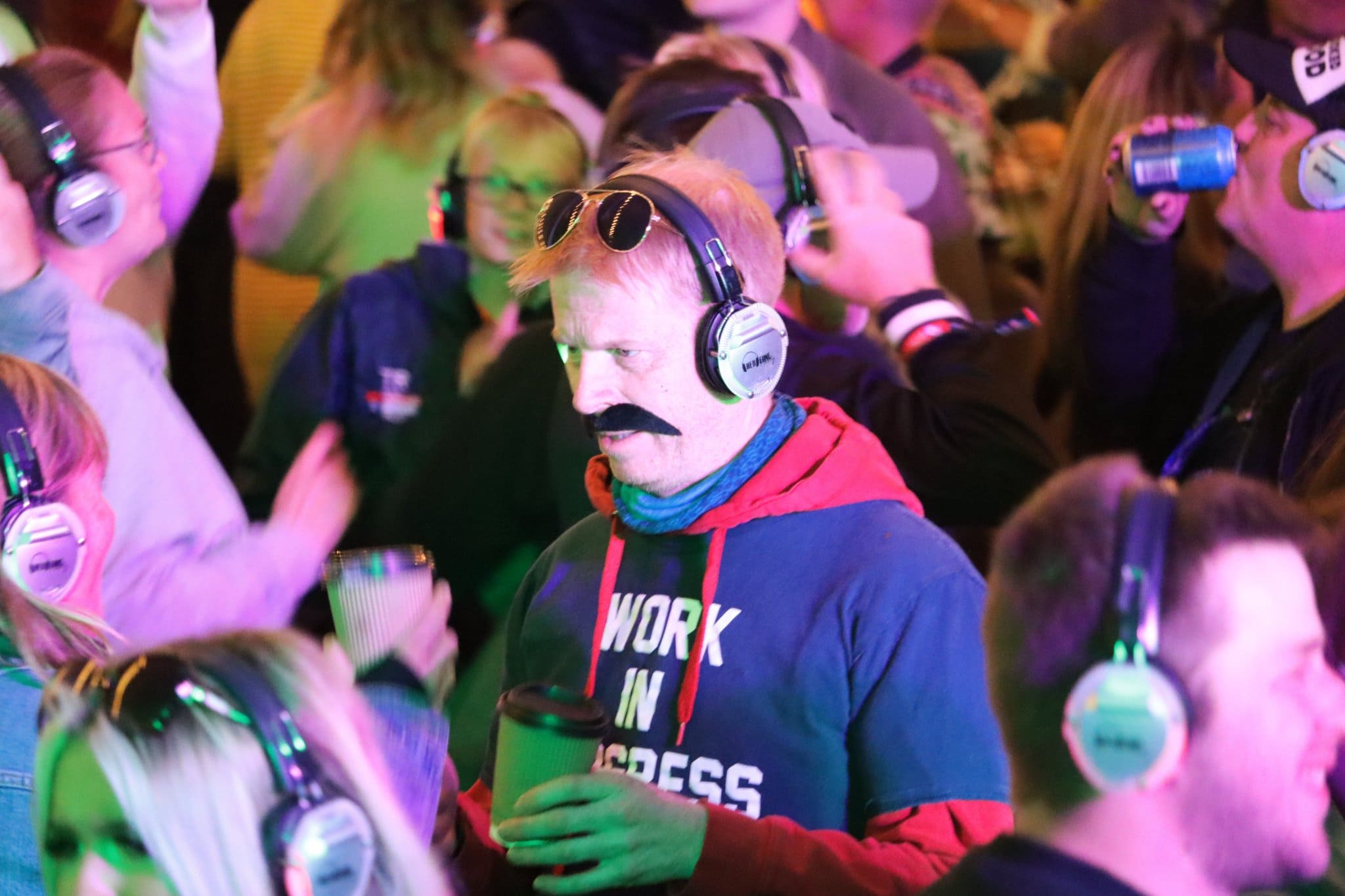 man with moustache enjoying silent disco